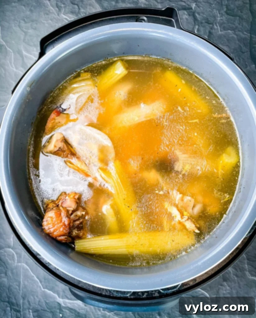 Rich Homemade Turkey Broth 4 Rich, golden turkey bone broth cooking in an Instant Pot.
