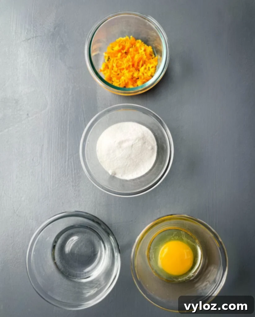 orange zest, sweetener, water, and an egg in separate bowls