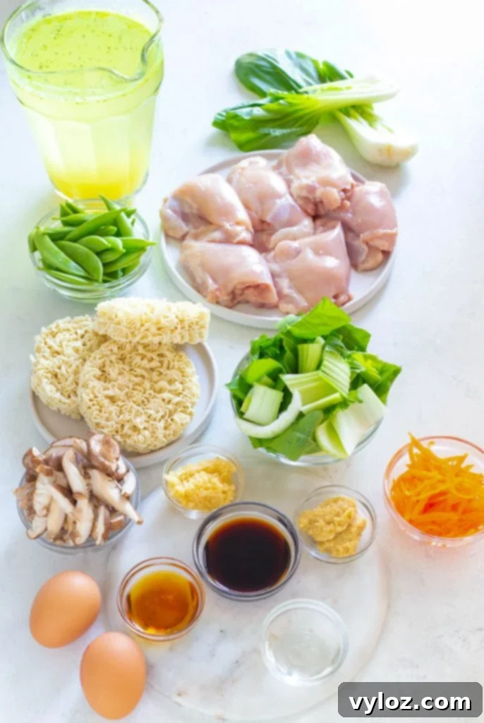 Ingredients for Instant Pot chicken ramen laid out: raw chicken thighs, bok choy, eggs, ramen noodles, and other fresh vegetables in separate bowls on a kitchen counter.
