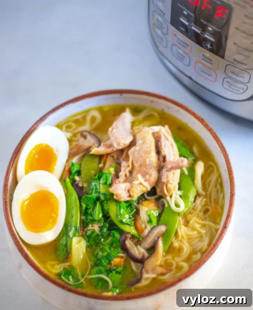 Instant Pot chicken ramen with soft-boiled eggs and green onions in a beautifully presented bowl.