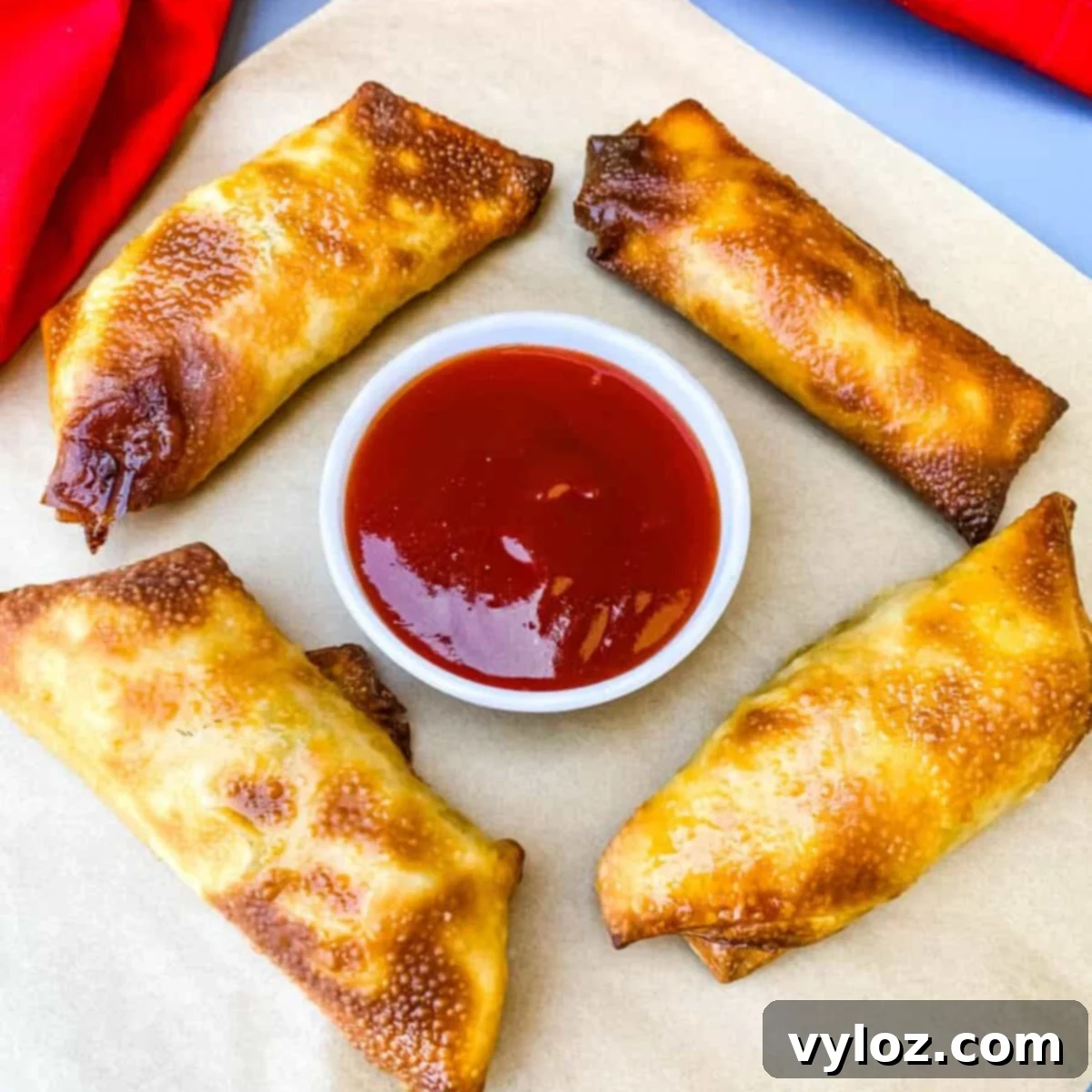 30 Quick and Delicious Air Fryer Appetizers 17 Crispy air fryer shrimp egg rolls on a serving plate.