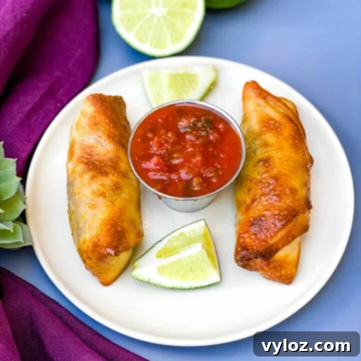 30 Quick and Delicious Air Fryer Appetizers 18 Air fryer beef taco egg rolls arranged on a platter.