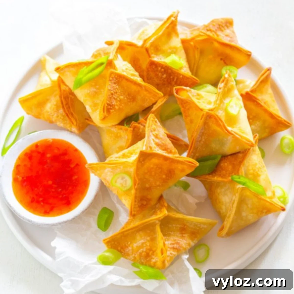 30 Quick and Delicious Air Fryer Appetizers 3 Golden brown crispy air fryer crab rangoons served with dipping sauce.
