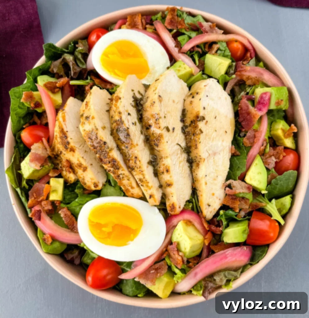 Green Goddess Cobb Salad being drizzled with creamy dressing