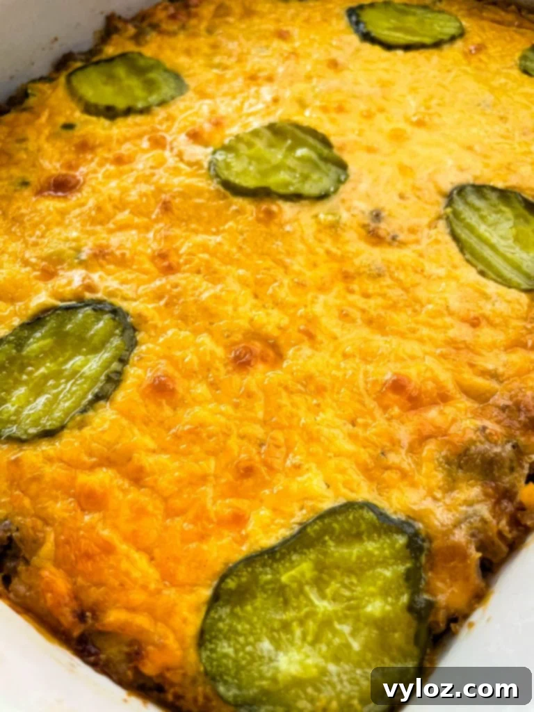Big Mac Bake 12 Another view of the Big Mac Casserole in its baking dish, topped with additional pickle slices, ready for a family meal or individual servings.