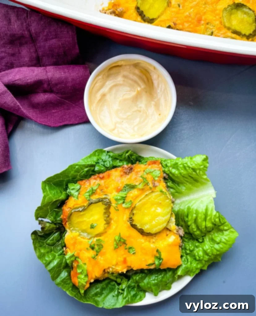 Big Mac Bake 13 A beautifully presented slice of Big Mac Casserole resting on a bed of fresh lettuce, generously topped with an extra dollop of Big Mac Sauce, highlighting its irresistible appeal.