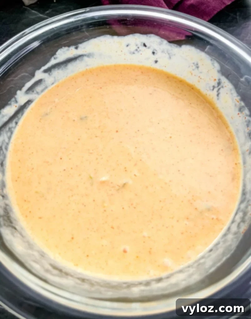 Big Mac Bake 6 A glass bowl filled with the homemade Big Mac Sauce, showcasing its creamy texture and signature color, ready to be incorporated into the casserole.