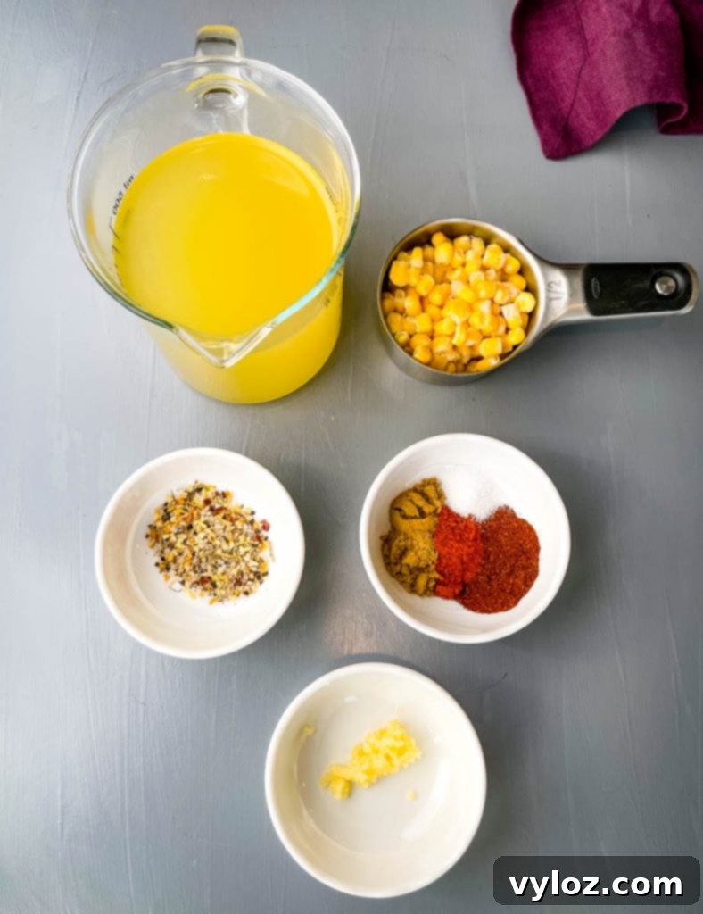 Various seasonings and ingredients for chili, including chicken broth, frozen corn kernels, a blend of chili spices, and minced garlic, presented in individual bowls.