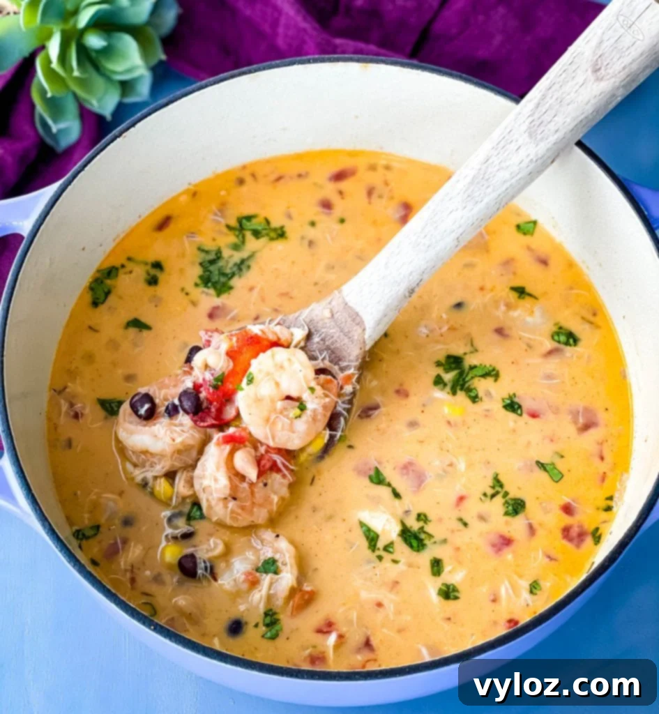 A large pot of creamy seafood and shrimp chili in a Dutch oven, showcasing its thick, rich texture and vibrant colors.