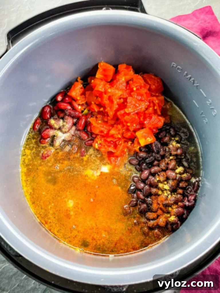 Tangy Buffalo Chicken Chili 6 A close-up view of Buffalo chicken chili simmering deliciously within an Instant Pot, showcasing its rich texture and vibrant colors.