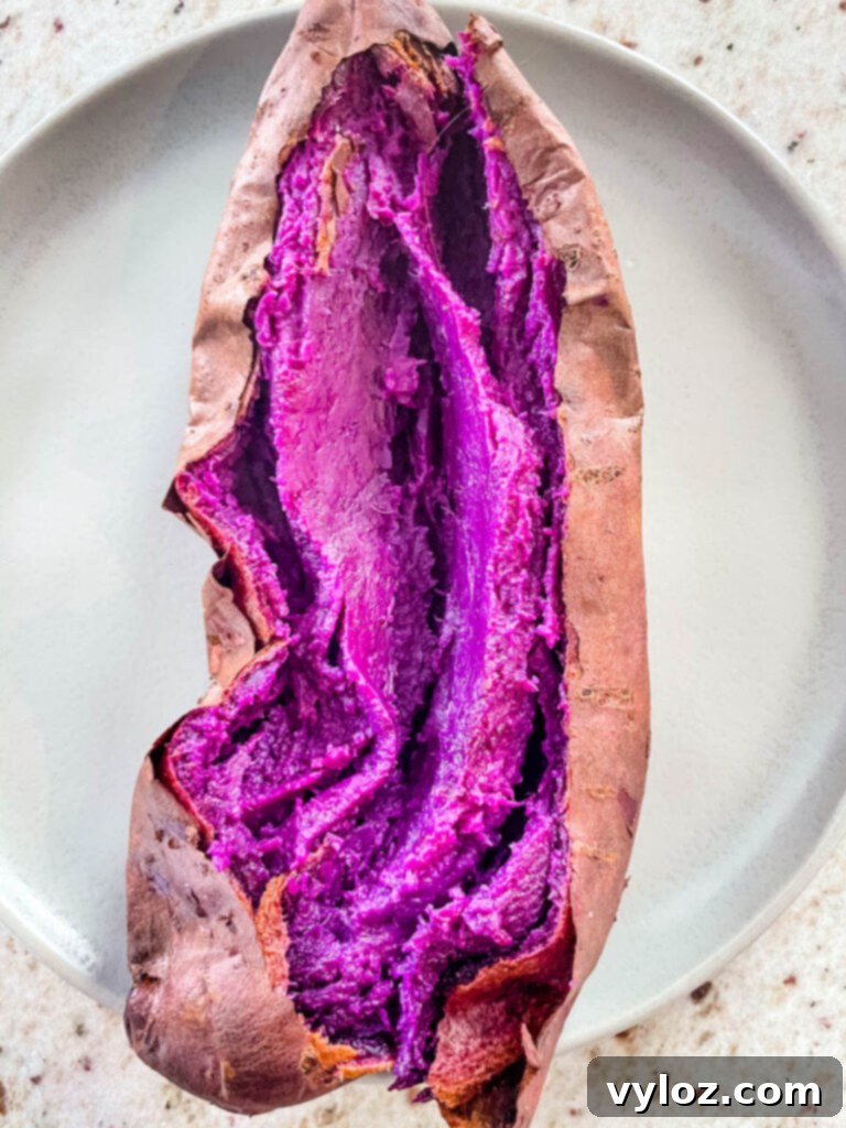 Stokes purple sweet potato fully cooked and sliced open on a plate