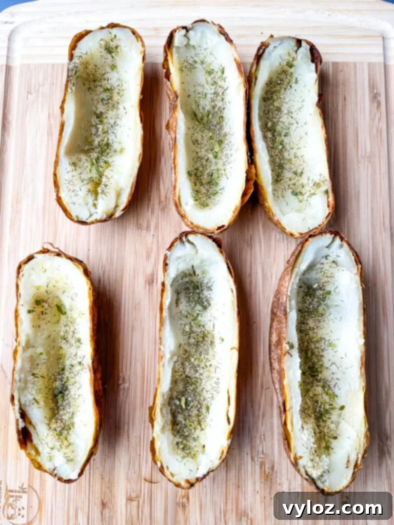 Baked Russet potatoes sliced in half and seasoned with ranch seasoning