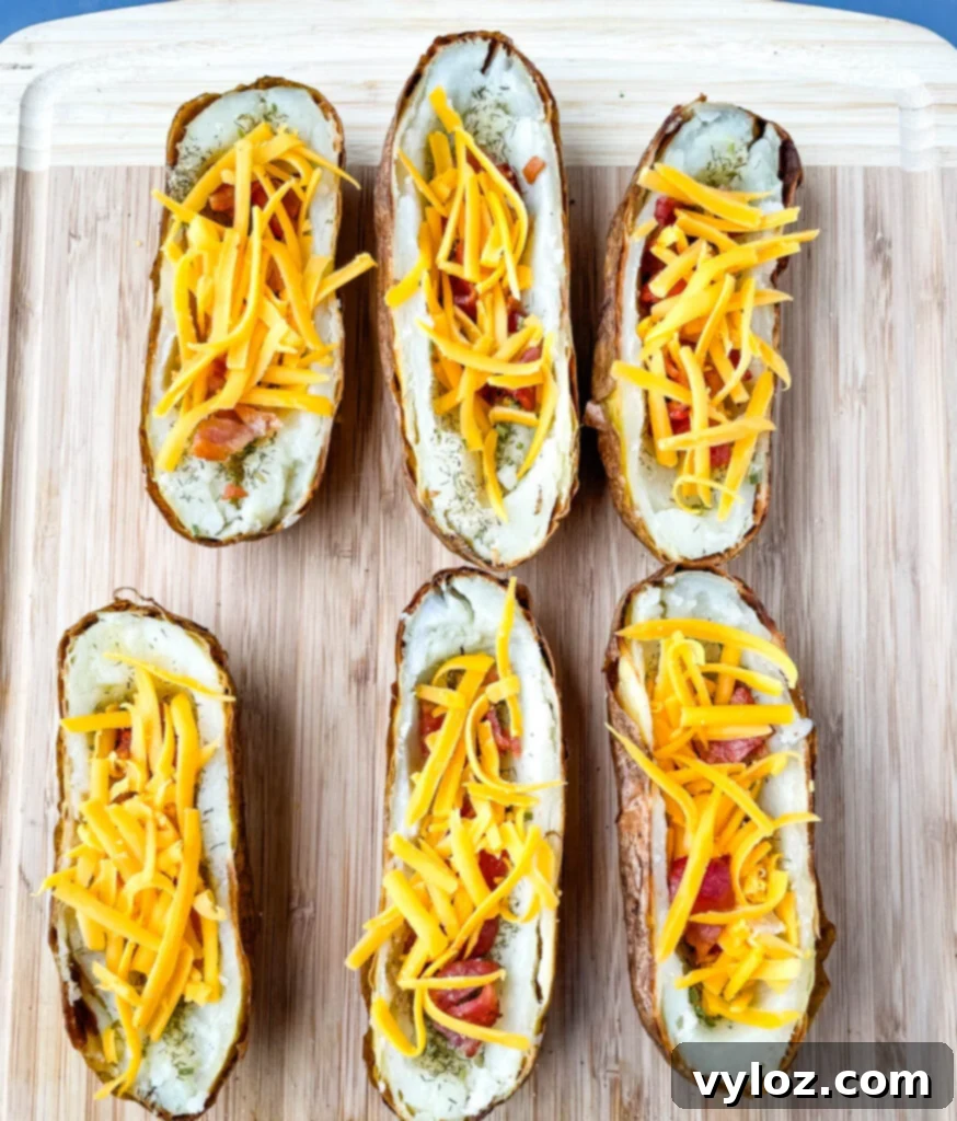 Finished potato skins on a bamboo cutting board, garnished with green onions