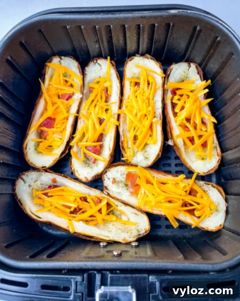 Potato skins being air fried in an air fryer basket