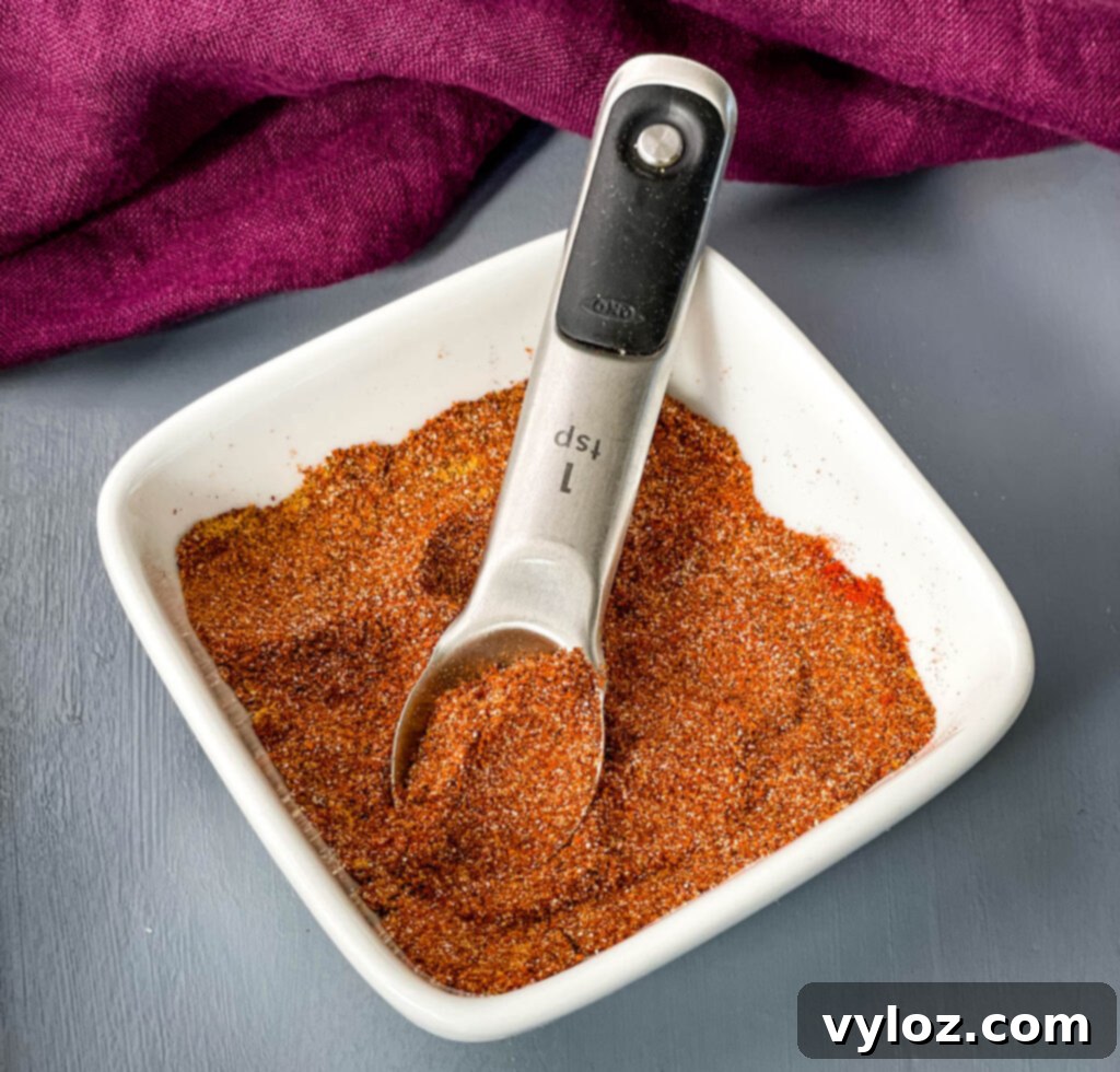 homemade taco seasoning in a white bowl with a spoon