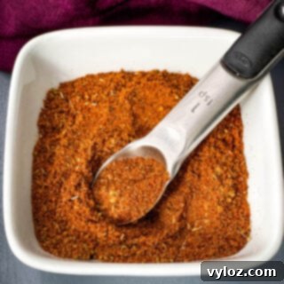 DIY Chili Spice Blend 7 Homemade chili seasoning in a white bowl with a spoon