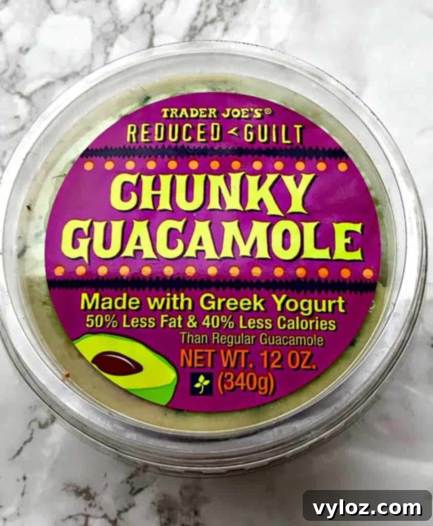 Effortless 20-Minute Low-Carb Sheet Pan Shrimp Fajitas 8 Plate of shrimp fajitas with guacamole and a fresh lime wedge