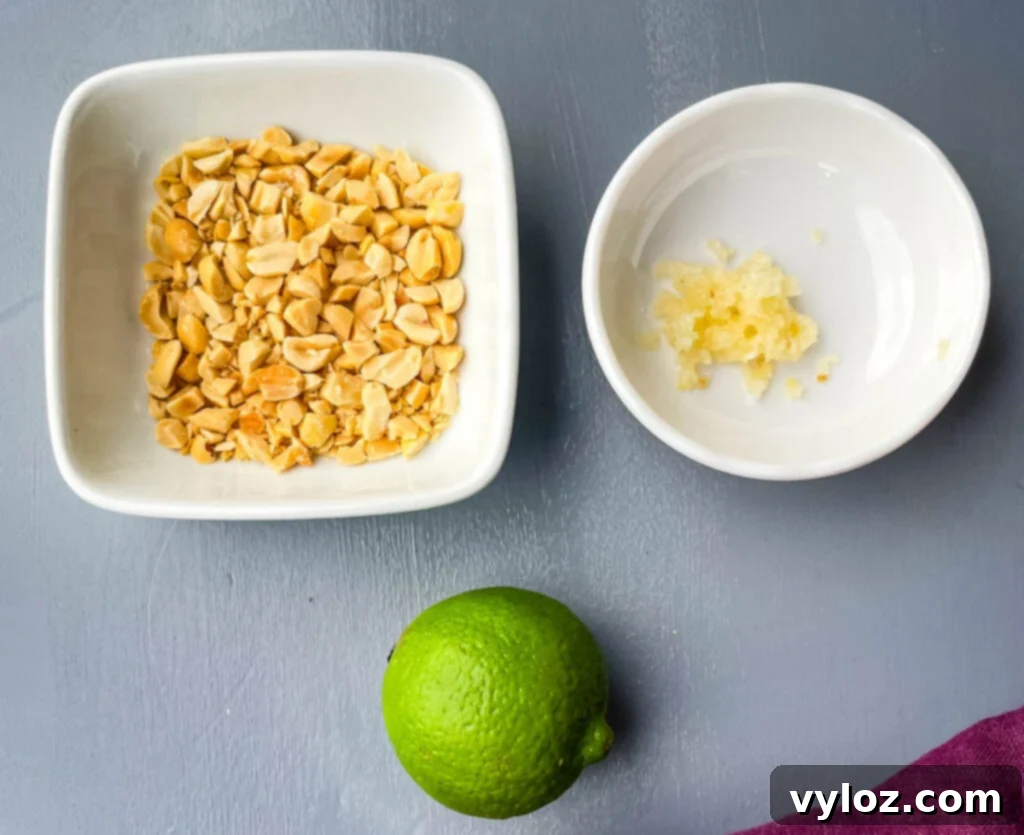 chopped peanuts, garlic, and a lime on a flat surface