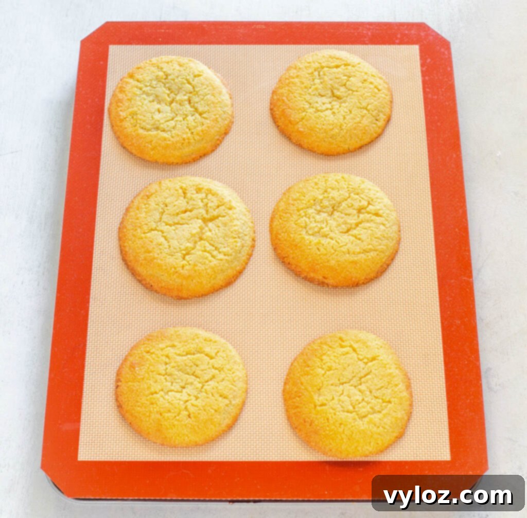 Zesty Sugar-Free Lemon Delights 5 keto low carb lemon cookies baking on a silicone mat, showing golden edges