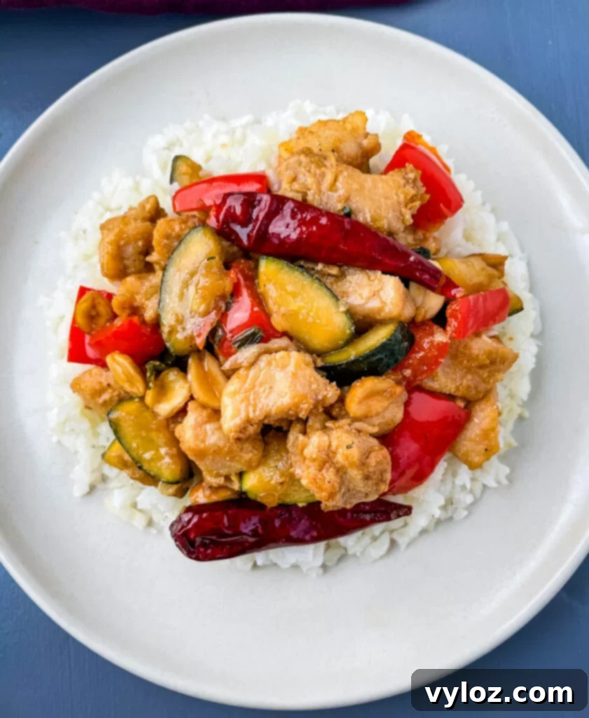 Panda Express copycat kung pao chicken on a white plate, ready to be enjoyed.