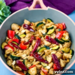 Panda Express copycat kung pao chicken on a skillet pan, garnished and ready to serve.