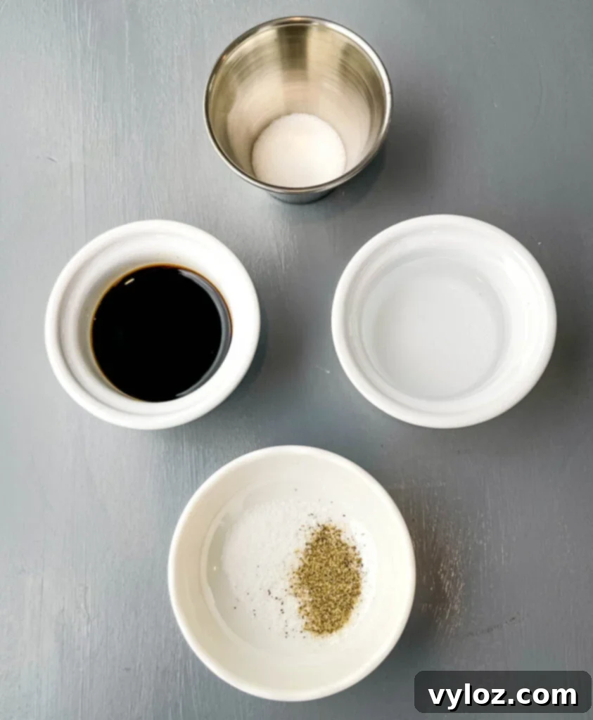 Soy sauce, rice vinegar, sweetener, salt, and pepper in separate bowls, prepared for the Kung Pao sauce.
