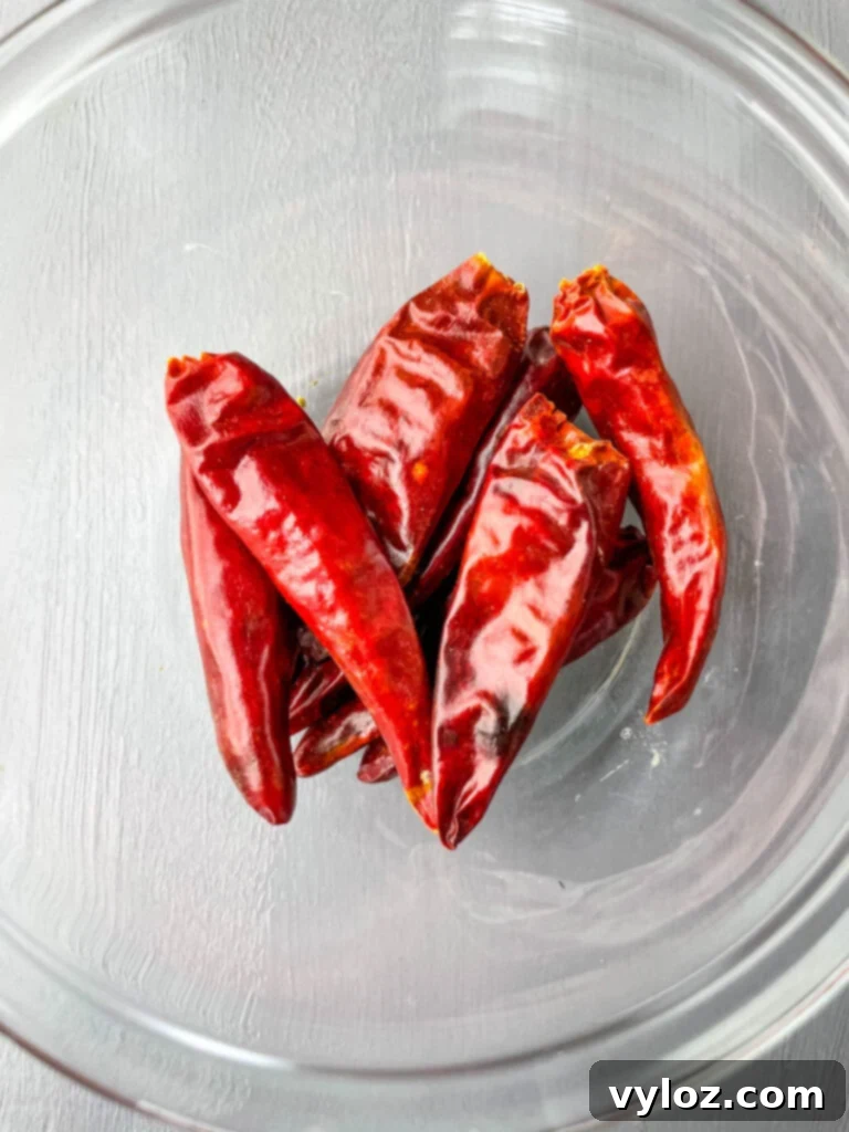 Dried chili peppers in a clear glass bowl, ready to add heat to the dish.