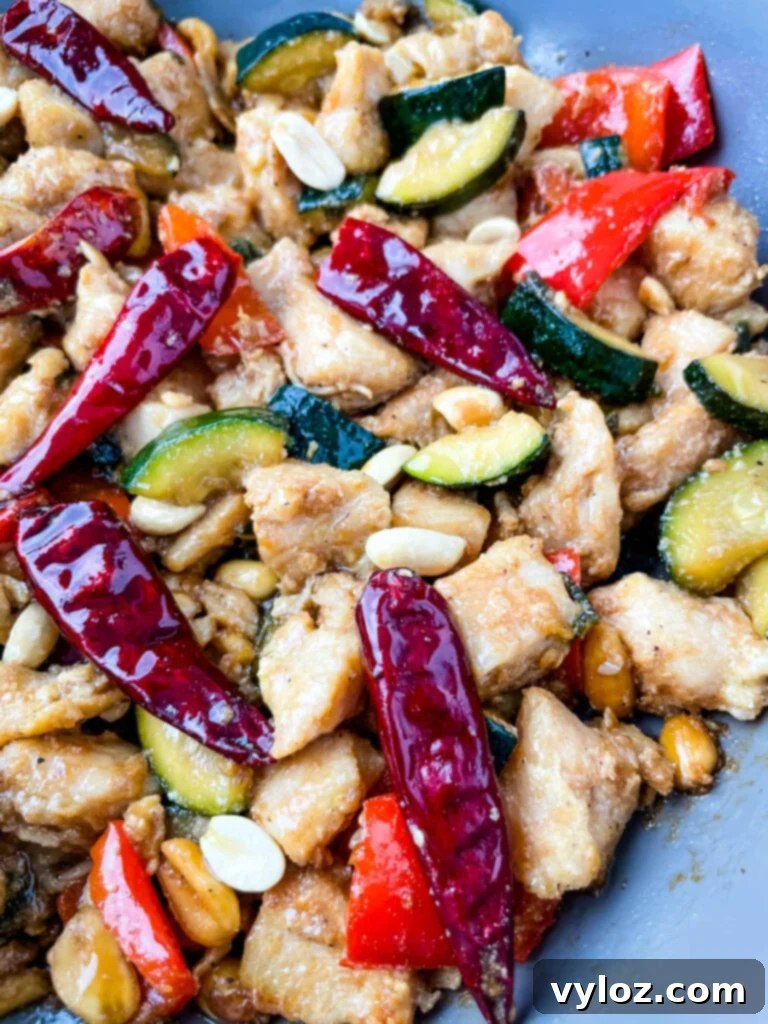 Panda Express copycat kung pao chicken on a skillet pan, garnished and ready to serve.