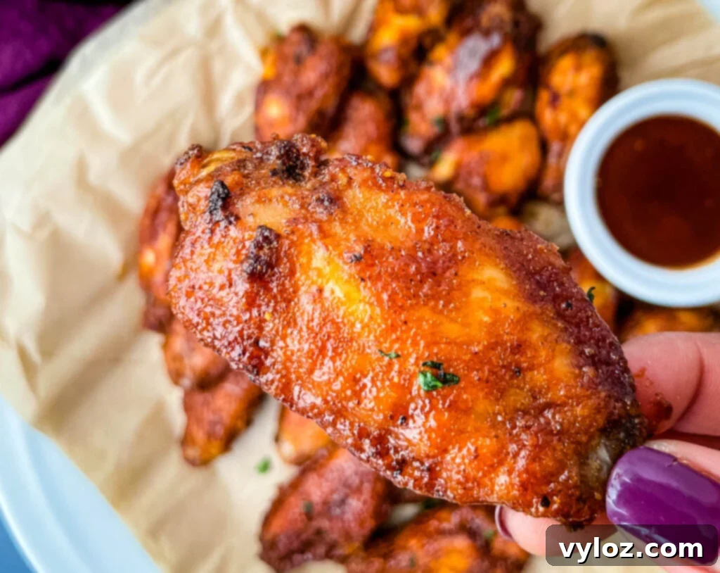 person holding keto chicken wing