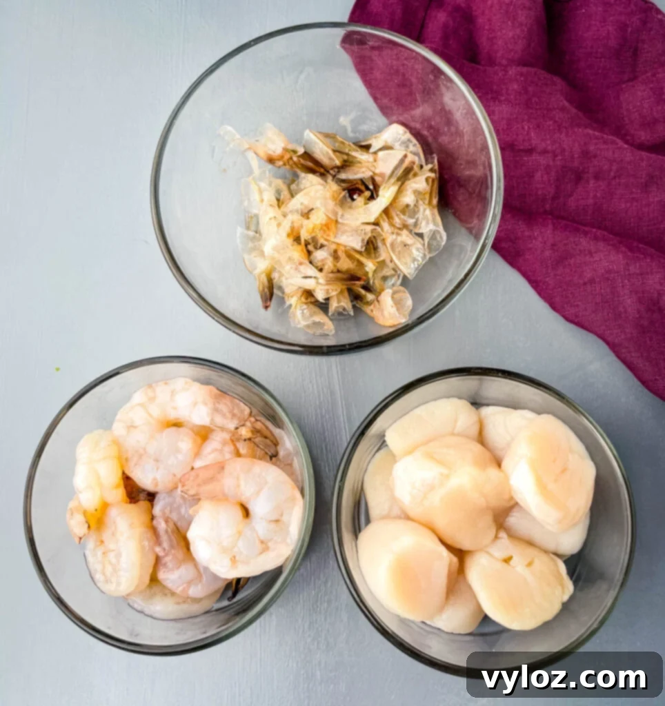 Spice selection for Pho broth: brown sugar, cinnamon stick, star anise, garlic, ginger, fish sauce, and soy sauce in separate bowls.