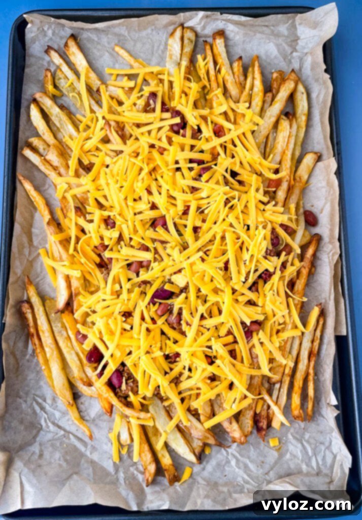chili cheese fries on a sheet pan