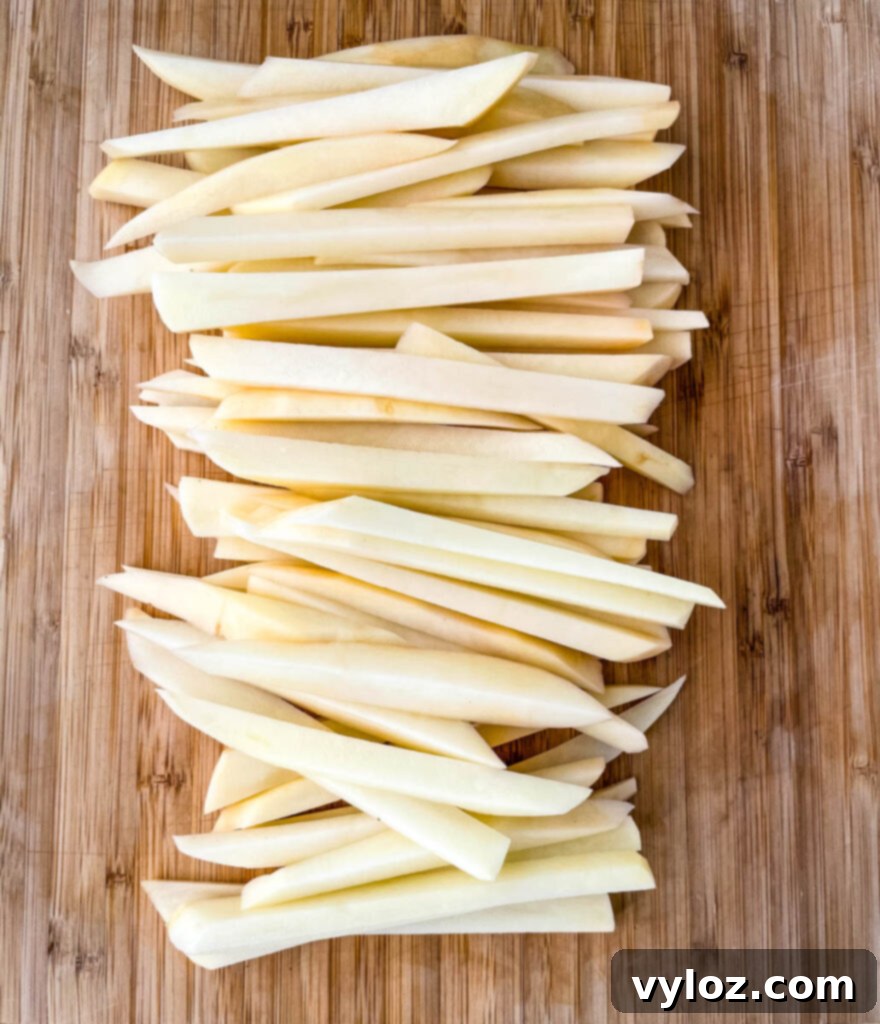 raw sliced potatoes on a cutting board