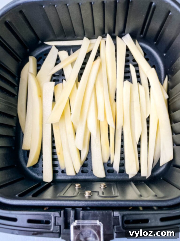 sliced potatoes in an air fryer