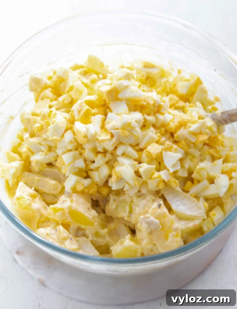 Grandmas Southern Soul Food Potato Salad 8 Instant Pot cooked potatoes in a glass bowl with sliced eggs