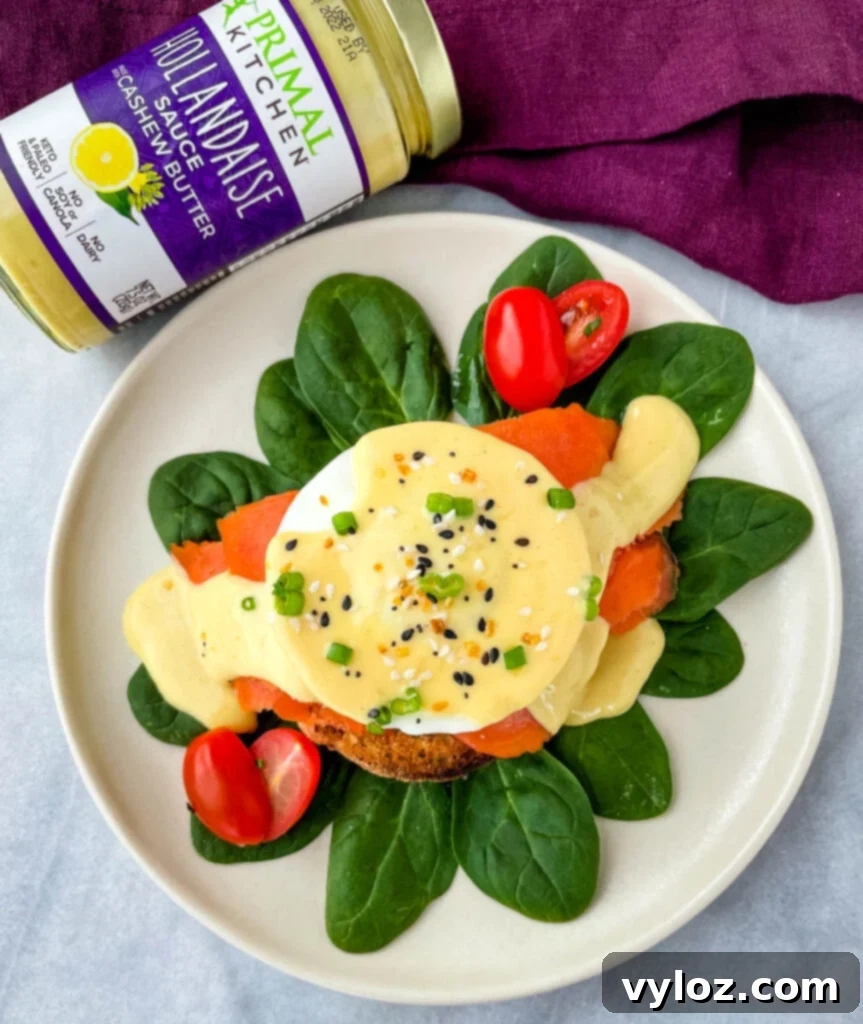 Two servings of smoked salmon eggs Benedict on a bed of fresh spinach, artfully arranged