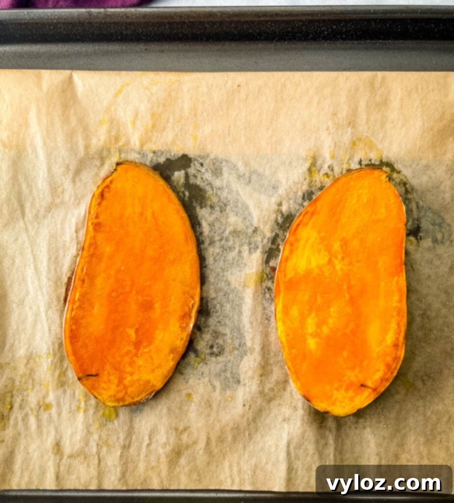 sliced baked sweet potatoes on a sheet pan
