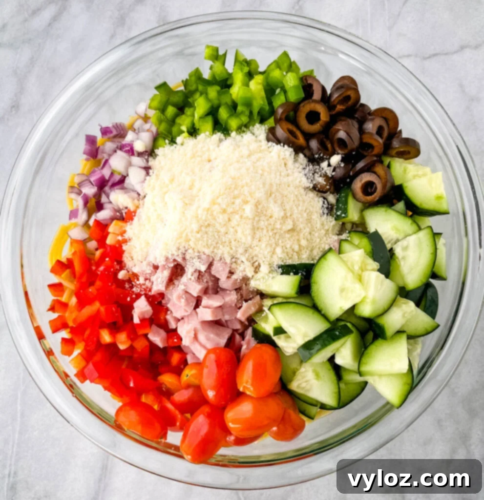 spaghetti salad and vegetables in a glass bowl