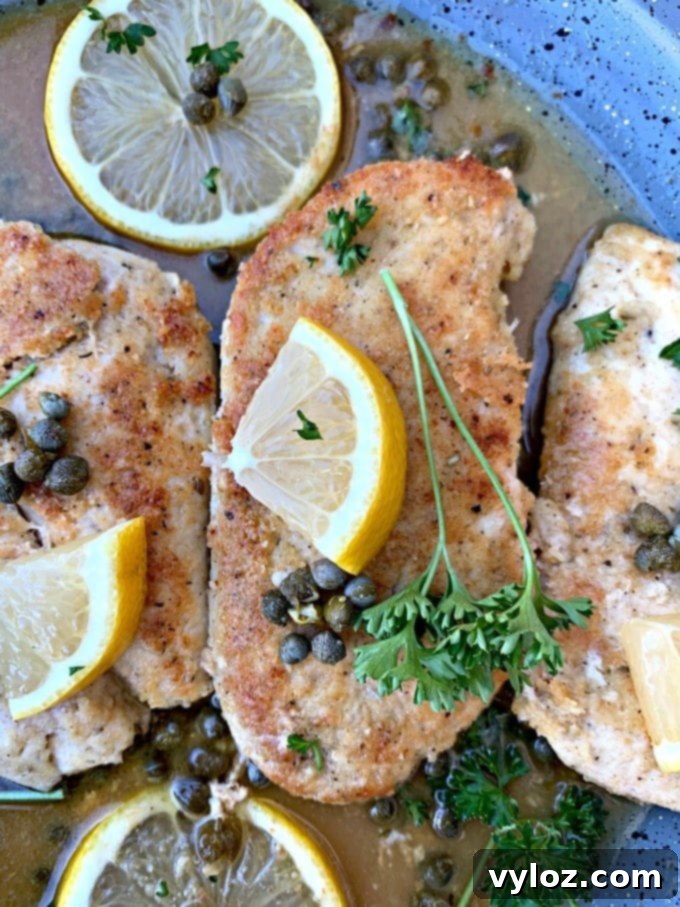 Keto Lemon Chicken Piccata in a skillet, close-up of the finished dish.