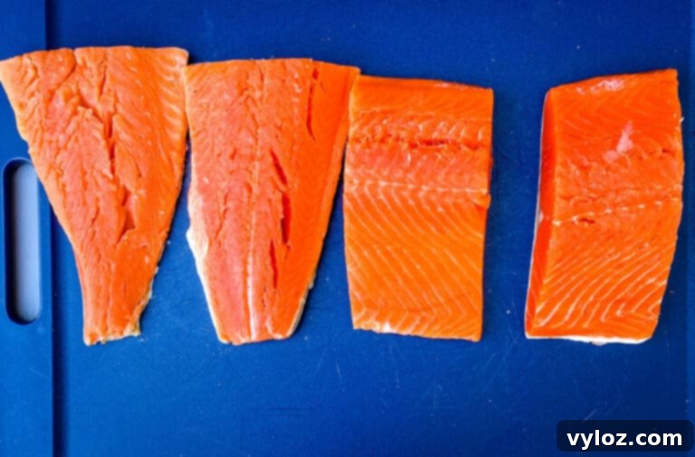 Fresh salmon fillets laid out, ready for preparation.