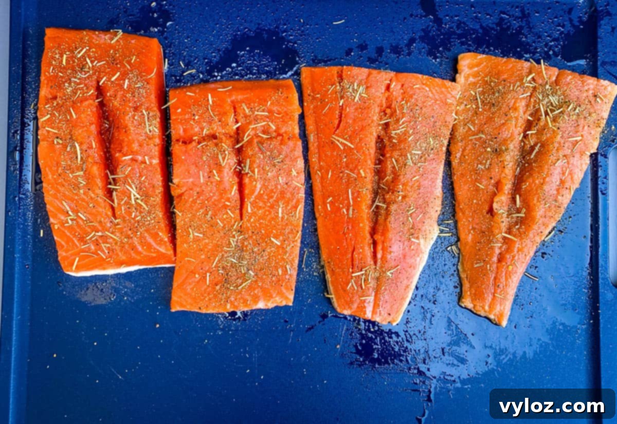 Expertly stuffed salmon fillets on a baking sheet, ready for the oven.