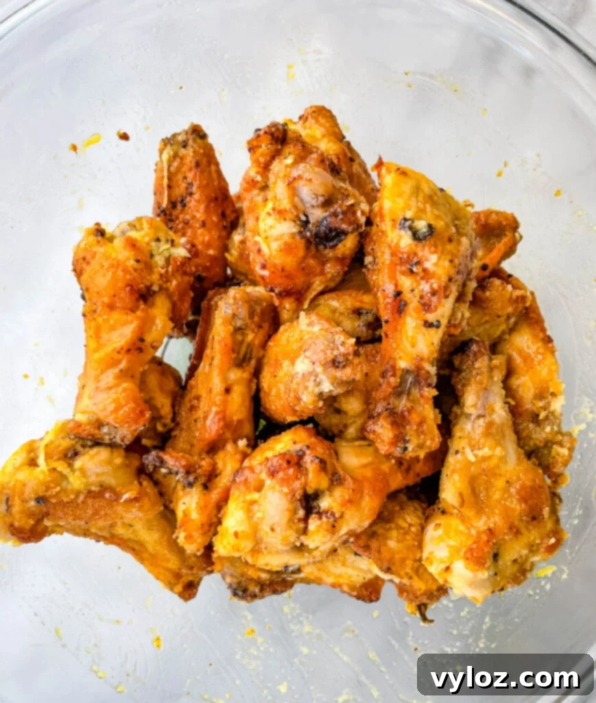 Perfectly cooked lemon pepper wings, garnished with fresh parsley, served in a glass bowl