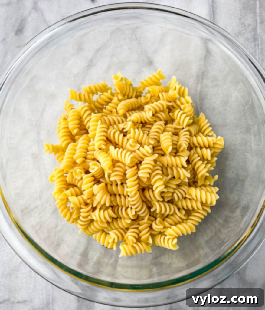 cooked rotini pasta in a glass bowl