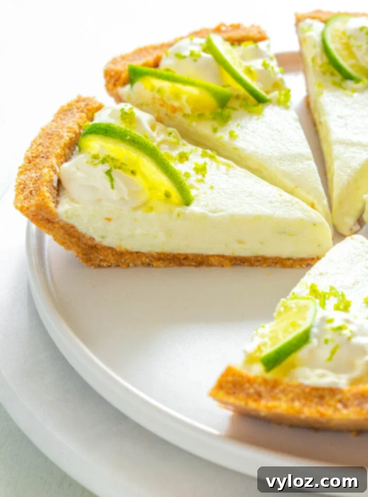 Guilt-Free Key Lime Bliss 11 A close-up shot of a slice of keto low carb key lime pie, highlighting its texture and the fresh lime garnish.