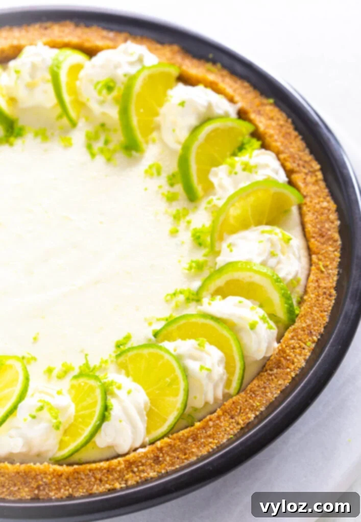 Guilt-Free Key Lime Bliss 9 Another view of a keto low carb key lime pie on a white plate, showcasing its creamy filling and golden crust.