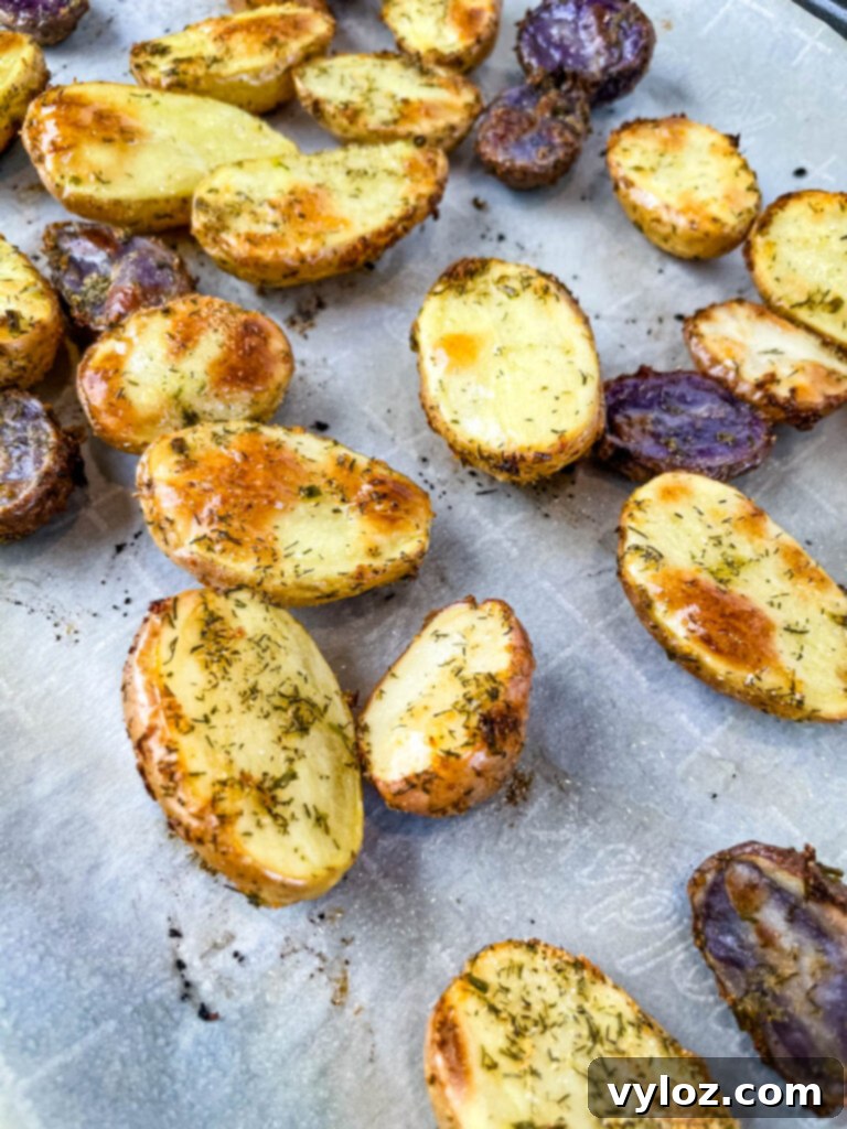 Crispy Ranch Roasted Potatoes 11 Roasted ranch potatoes spread on a sheet pan after baking, golden and delicious