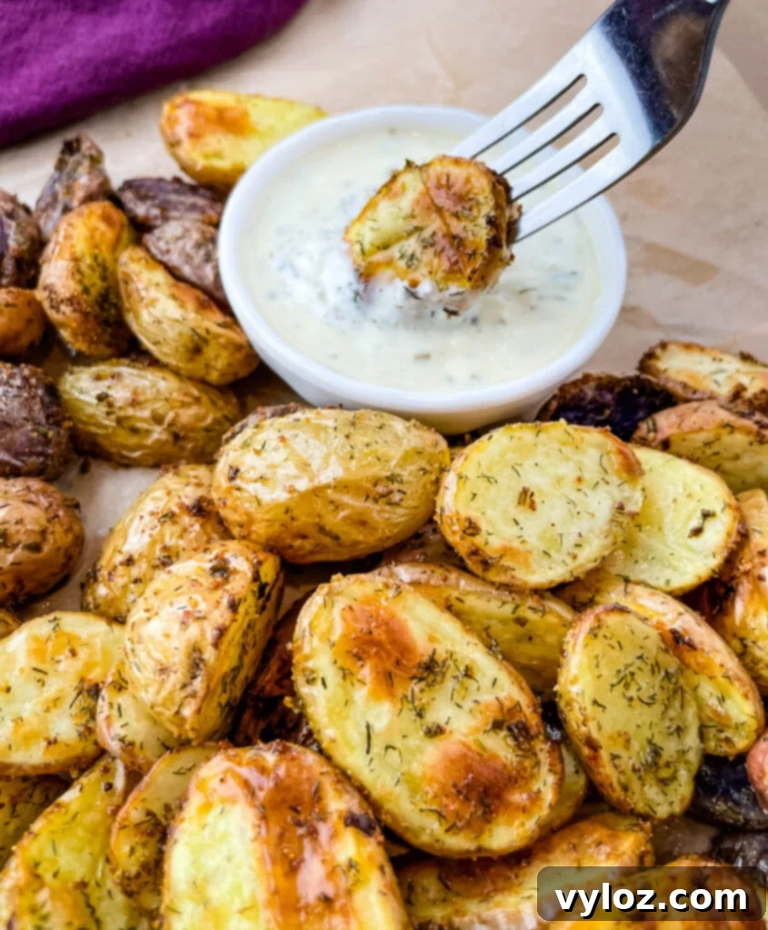 Crispy Ranch Roasted Potatoes 13 A single roasted ranch potato on a fork, dipped in creamy ranch dressing