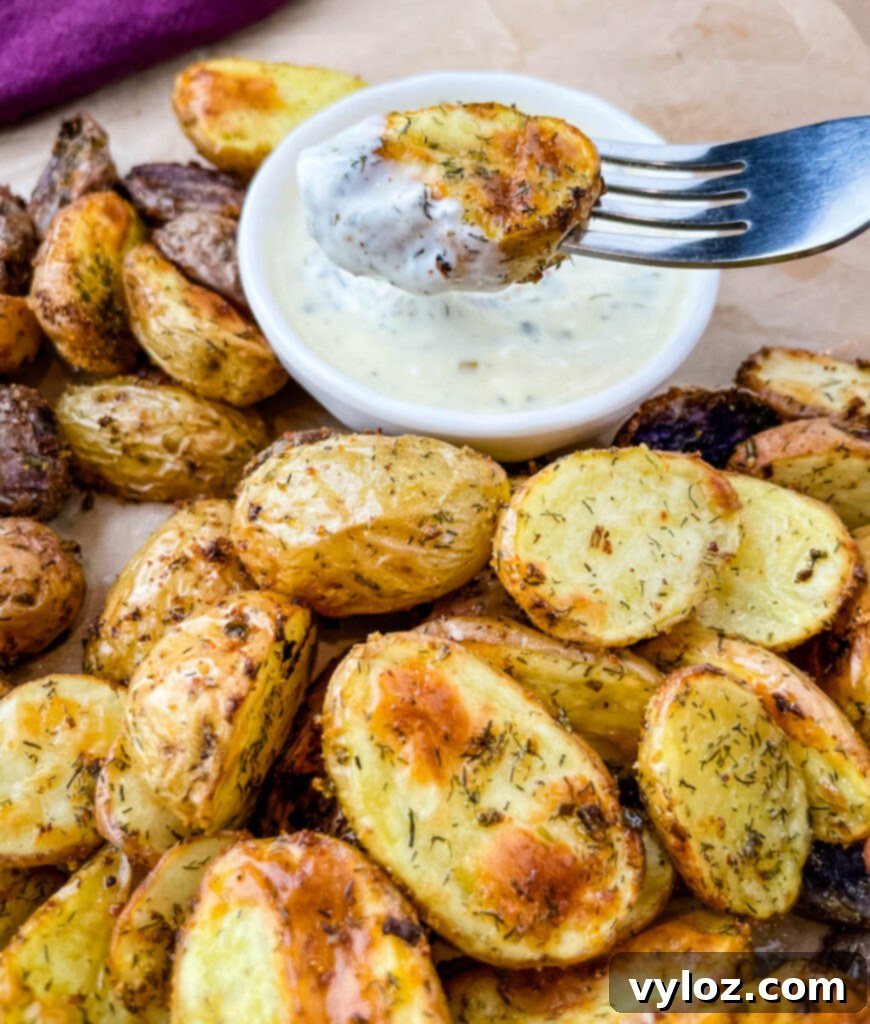 Crispy Ranch Roasted Potatoes 14 Another close-up of a roasted ranch potato on a fork, dipped in ranch dressing