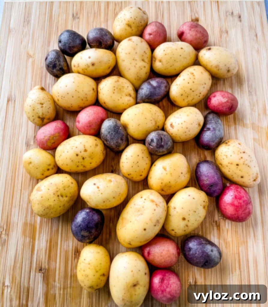 Crispy Ranch Roasted Potatoes 3 Close-up of vibrant baby Dutch yellow potatoes on a rustic bamboo cutting board