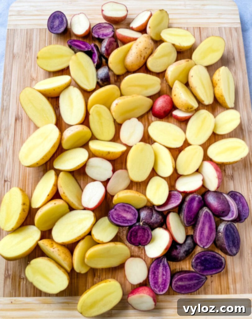 Crispy Ranch Roasted Potatoes 4 Neatly sliced raw potatoes on a bamboo cutting board, ready for seasoning