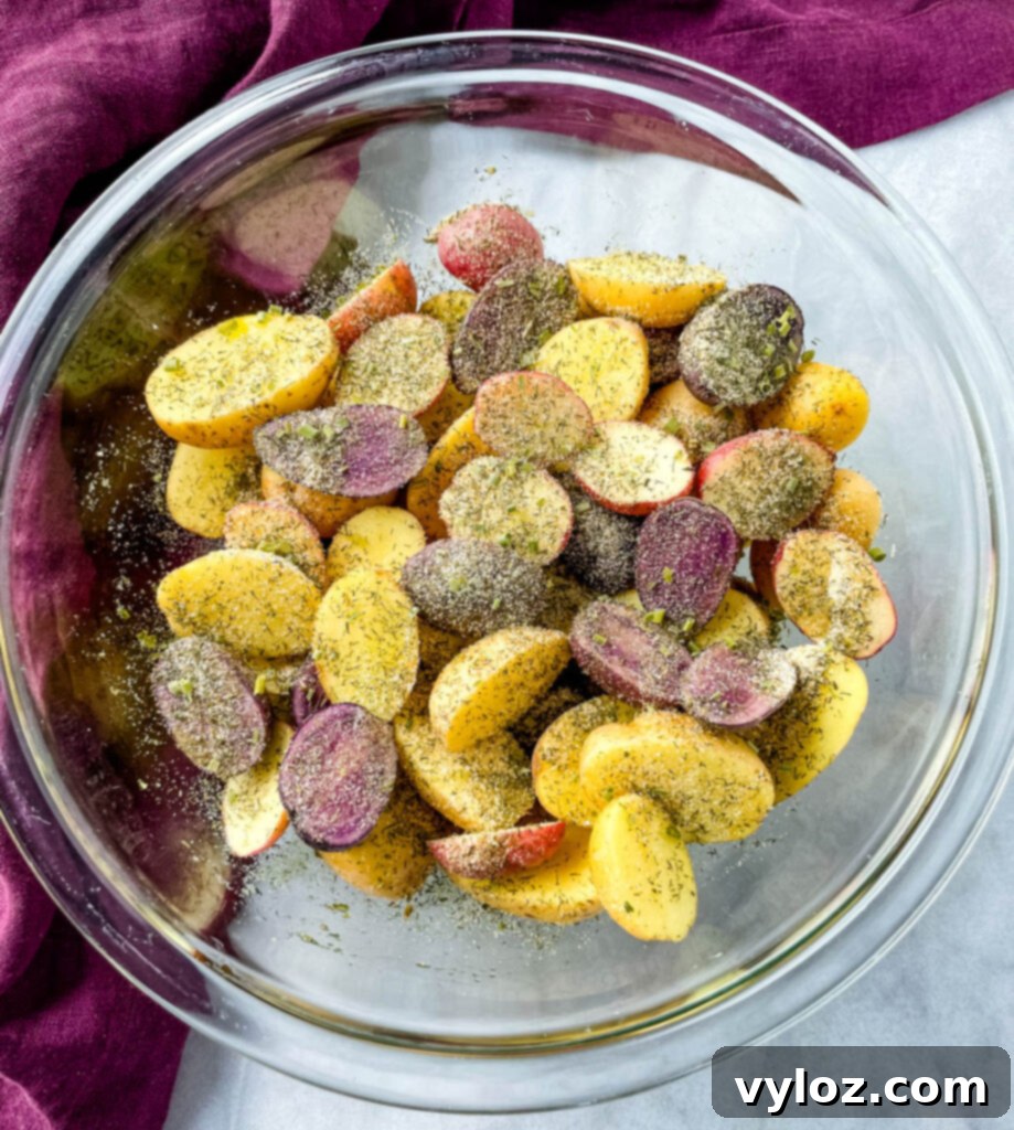 Crispy Ranch Roasted Potatoes 6 Raw sliced potatoes in a glass bowl, mixed with homemade ranch seasoning